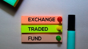 close-up of the phrase 'exchange traded fund' on three colorful papers pinned to a wall by pushpins