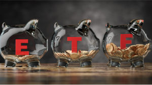 An image of three glass piggy banks with ETF written on the sides on a table. the best ETFs