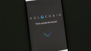 Holochain website displayed on smartphone screen.