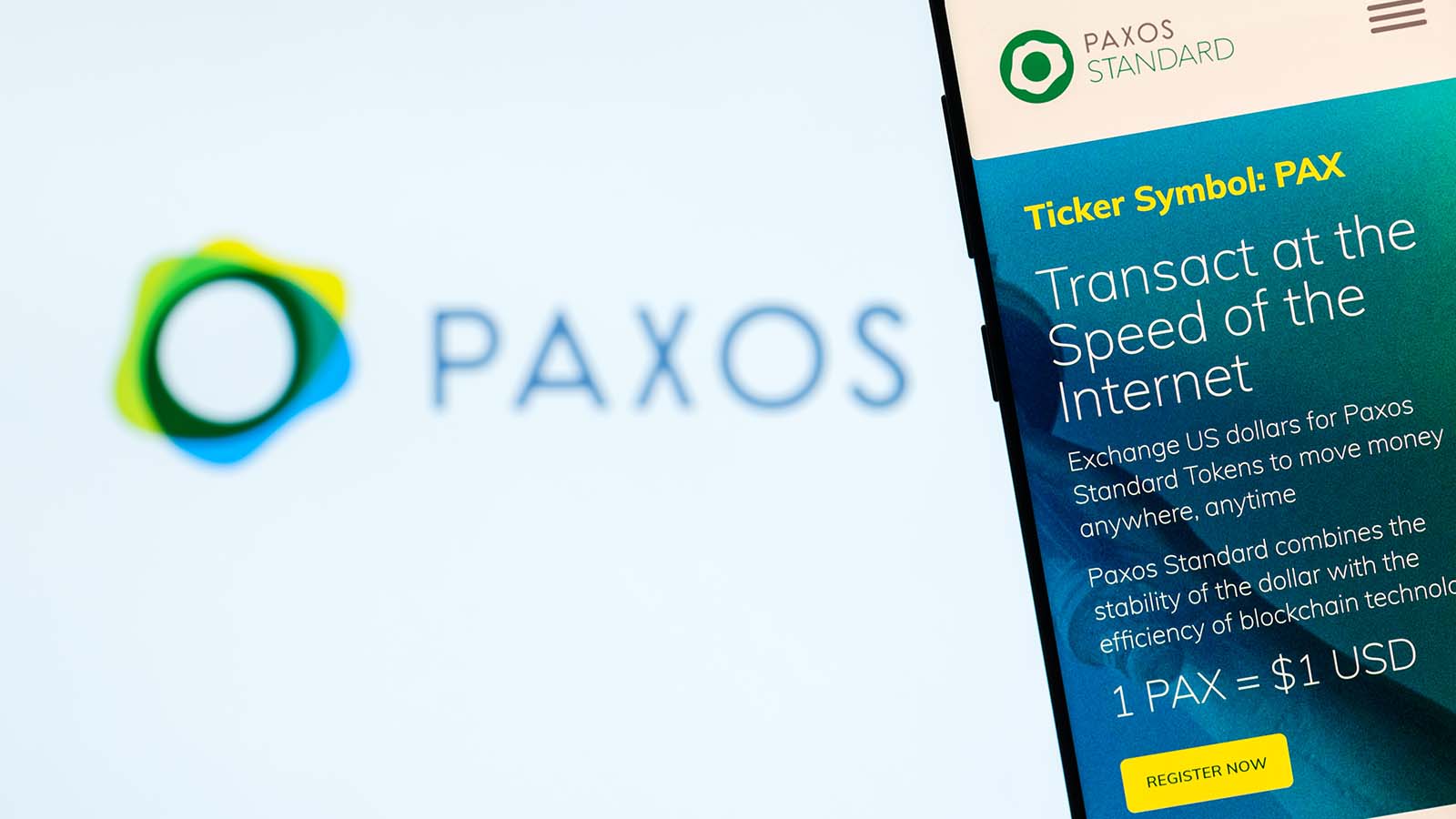 The website for the Paxos (PAX) crypto displayed in front of a logo background.