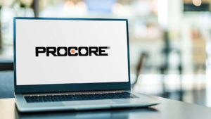 A laptop displays the logo for Procore Technologies (PCOR).