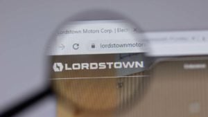 A magnifying glass zooms in on the website for Lordstown Motors (RIDE).