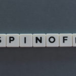 The word spinoff spelled out on plastic cubes. spin-off stocks