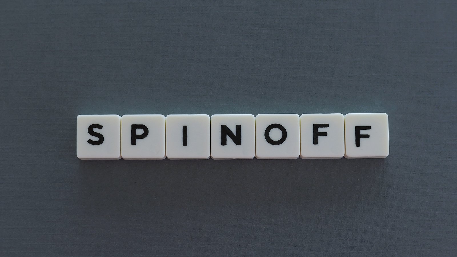 The word spinoff spelled out on plastic cubes representing XPER stock.