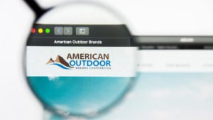 A magnifying glass is focused on the logo for American Outdoor Brands on the company's website.