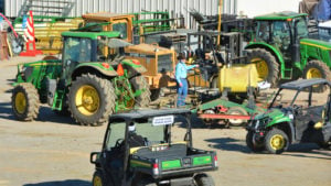 Several John Deere vehicles are parked outside the building.