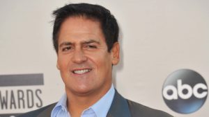 A close-up shot of Mark Cuban in front of a red carpet background.