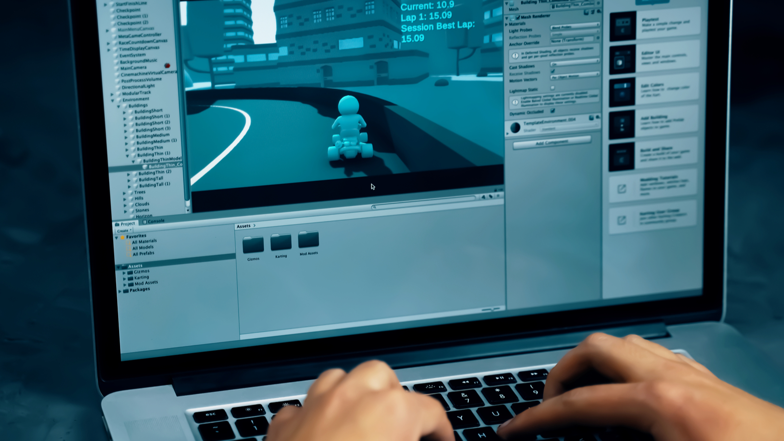A developer works on a 3D racing game in the Unity engine on a laptop.