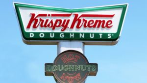 A close-up of a sign for Krispy Kreme (DNUT) donuts.