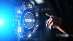 undervalued fintech stocks A concept image of a hand reaching toward the word "Fintech," which is surrounded by icons representing money and growth. Fintech Stock Bargains, fintech stock