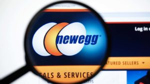 A magnifying glass zooms in on the website for Newegg (NEGG)