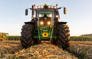 Deere equipment in harvested field. best infrastructure stocks