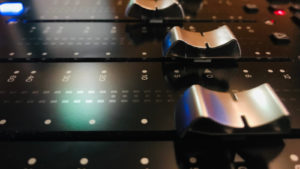 AVID stock: close up of Avid Technology sound mixing board