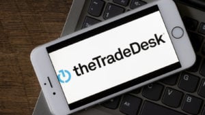 The Trade Desk logo is displayed on a smartphone.