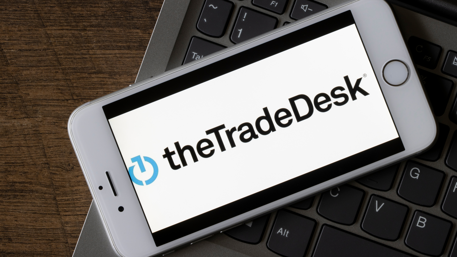 The logo for The Trade Desk is displayed on a smart phone representing TTD stock.