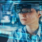 industrial factory chief engineer wearing AR headset. Augmented Reality Stocks to Sell
