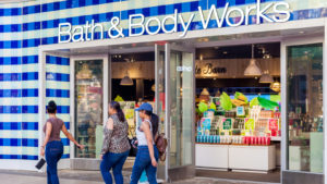 A photo of three women walking by a Bath&Body Works storefront.