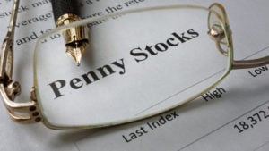 Page of newspaper with words penny stocks. high return penny stocks