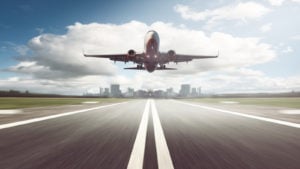 a jet takes off on a clear runway representing Airline Stocks.