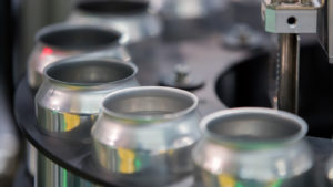 close-up of aluminum cans in assembly line