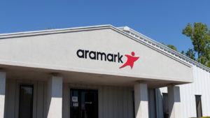 A photo of a building with the Aramark (ARMK) logo on it over the door.