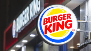 A photo of a Burger King light-up sign outside a Burger King restaurant.