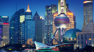 A photo of the Shanghai skyline at night featuring the Oriental Pearl Tower representing Chinese tech stocks.