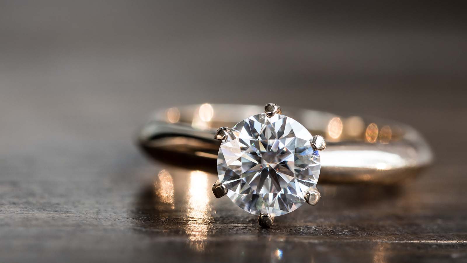 A close-up shot of a diamond engagement ring with a rose-gold band. Hidden Gem Stock picks