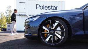 Close-up of a Polestar car in front of a company sign.