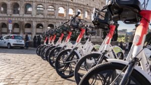 A row of Helbiz (HLBZ) bikes.