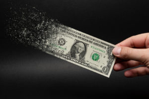 one dollar bill is sprayed in the hand of a man on a black background