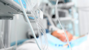 A photograph of various medical tubes attached to equipment in a hospital.