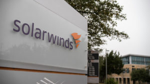 A sign with the logo for SolarWinds (SWI) is seen in front of an office building.