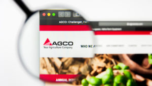An image of AGCO's website, with a magnifying glass over the company logo.
