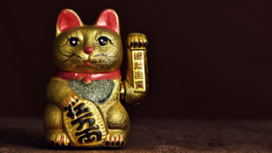 Image of a Japanese lucky cat statue representing Catecoin (CATE) crypto.