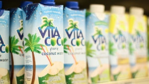 A line of Vita Coco (COCO) waters on a shelf.