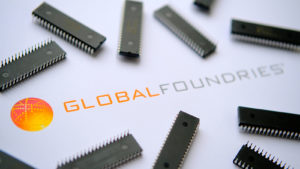 Computer chips scattered across the logo for Global Foundries.