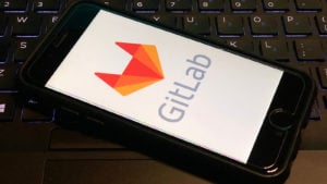 The GitLab (GTLB) logo on an iPhone screen.