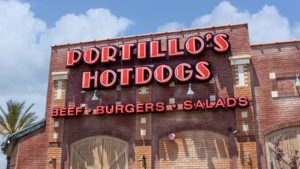 The front of a Portillo's (PTLO Stock) hotdog restaurant in Riverside, California representing its IPO.