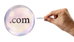 A concept image of a person popping a bubble labeled "dot-com" with a needle.