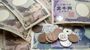 Japanese yen bills and coins representing Gyen crypto price predictions.