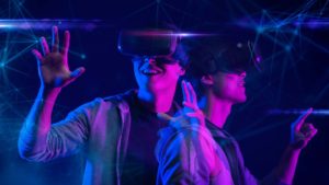 A concept image of the metaverse with two young adults wearing virtual reality headsets.