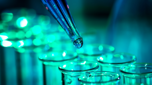 Pipette adding fluid to one of several test tubes; biotech Small-Cap Growth Stocks 