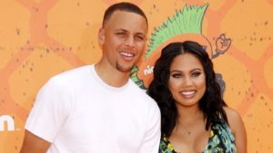 A close-up shot of Steph and Ayesha Curry in front of a Nickelodeon background.