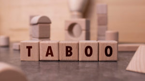 Wooden blocks display the word "taboo".