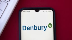 The logo for Denbury (DEN) is shown on a cellphone screen.