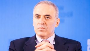 A close-up photo of Garry Kasparov in front of a blue background.