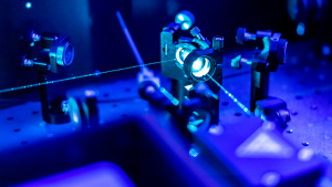 a blue laser and microscope representing LASE stock. Tech Stocks to Buy