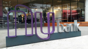 A Nubank sign outside of an office building.