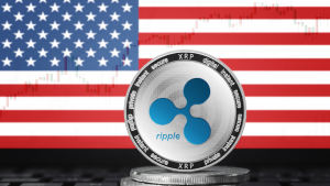 RIPPLE (XRP) cryptocurrency; physical concept ripple coin on the background of the flag of United States of America (USA). XRP crypto